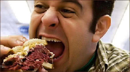 Adam Richman Eating a Sandwich